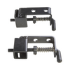 Two black metal hinges with springs on a white background