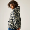 A woman with curly hair is shown from the back wearing a hooded jacket with a bold black and off-white floral pattern, set against a plain light gray studio background.