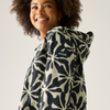A woman wearing a hooded jacket with a bold black and cream floral pattern, photographed against a plain light background.