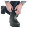 Person adjusting a black rubber boot on a white background