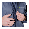 Person zipping up a blue jacket with AgriShield logo on a white background