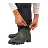 Person wearing green rubber boots with a white background