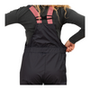 Person wearing a black snowsuit with pink straps on a white background