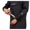 Person wearing an AgriShield coat holding a pair of scissors on a white background