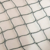 Close-up of a black safety net or mesh overlay laid over a white background.