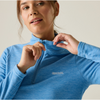 A close-up of a woman wearing a heather blue long-sleeve quarter-zip pullover with the regatta logo on the left chest, set against a plain light beige background.