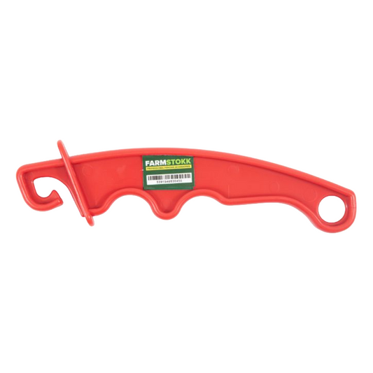 Red plastic tool with a green label on a white background