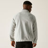 Man wearing a gray fleece jacket on a plain background