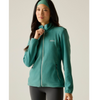A woman wearing a teal fleece zip-up jacket and a matching teal headband, paired with dark gray leggings, against a plain light beige studio background.