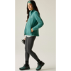 A woman modeling a teal zip-up fleece jacket, dark gray leggings, and matching teal hiking boots against a light gray studio background.