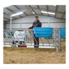 Person operating agricultural equipment in a barn setting