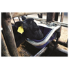 Calf drinking from a purple water bowl attached to metal bars.