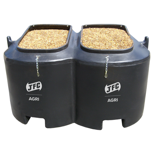 Black JFC Agri feed trough with two compartments filled with grain on a white background