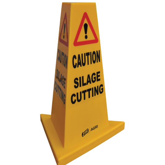 Yellow plastic agricultural warning sign cone with black text reading 'CAUTION SILAGE CUTTING' and a red triangular warning symbol on a white background.