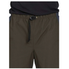 Close-up of a person wearing dark olive green drawstring shorts with a black waistband and black drawstring, paired with a black top against a white background.