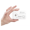 Hand holding a Kidde carbon monoxide alarm on a white background