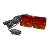 Pair of red and amber trailer lights with wiring on a white background