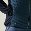 Close-up of a person wearing a dark teal puffer vest over a navy long-sleeve shirt, with a small white WARMLOFT logo near the lower front pocket.