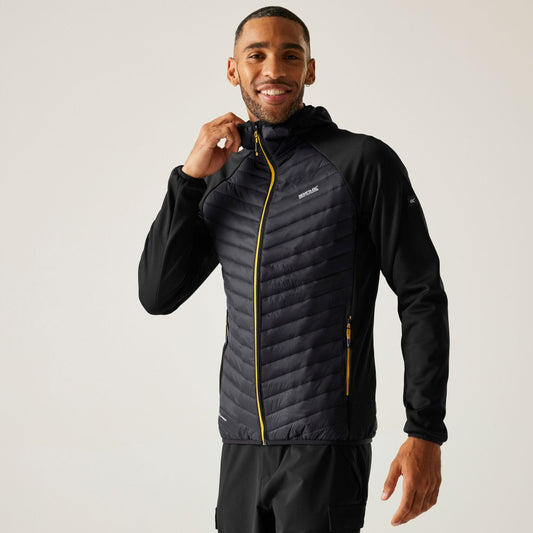 Man wearing a black jacket with yellow accents on a plain background