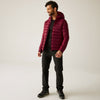Man wearing a maroon puffer jacket on a white background