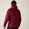 Person wearing a maroon puffer jacket on a plain background