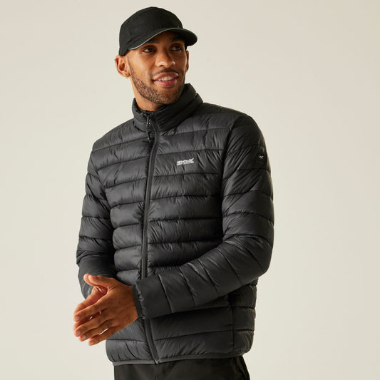 Man wearing a black puffer jacket with a visible brand logo on a plain background