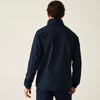 Person wearing a navy blue jacket on a plain background