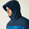 Person wearing a blue hooded jacket with a visible brand logo on a plain background