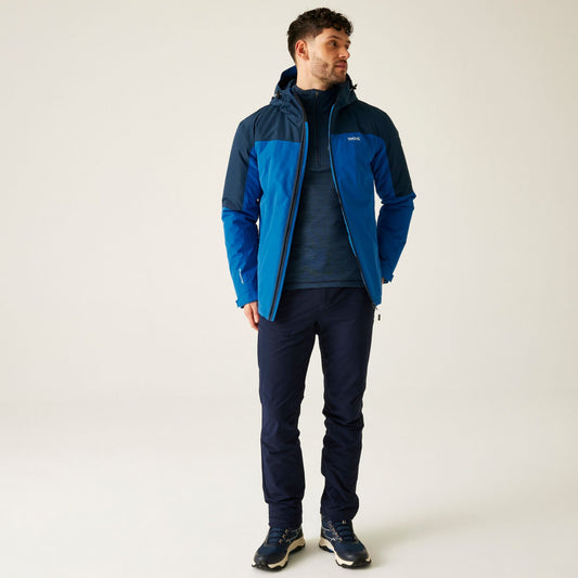 Man wearing a blue jacket and pants on a white background