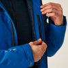Close-up of a person adjusting the zipper of a blue jacket against a neutral background