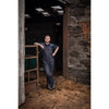 lifestyle image of the No Sweat Stormgear Waterproof Bib & Brace in Navy on a farmyard
