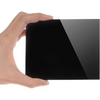 A hand holding a rectangular black glossy panel or card against a plain white background.
