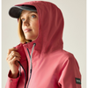 close up of woman wearing pink jacket with hood up over head wearing navy cap and holding collar