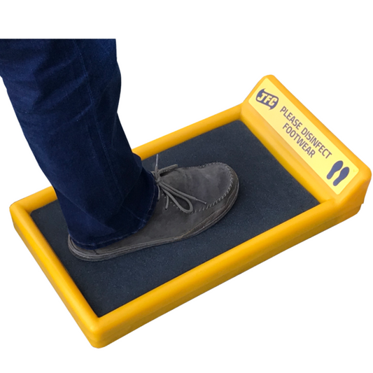 yellow and black footbath with persons foot in bath on white background