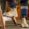 lifestyle photo of brown boots on a person who's using a stepladder