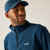 Man wearing a blue Regatta fleece jacket and cap against a plain background