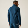 Man wearing a blue fleece jacket and pants on a plain background