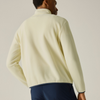 A man shown from the back wearing a pale cream fleece pullover and navy pants, photographed against a plain light beige studio background.