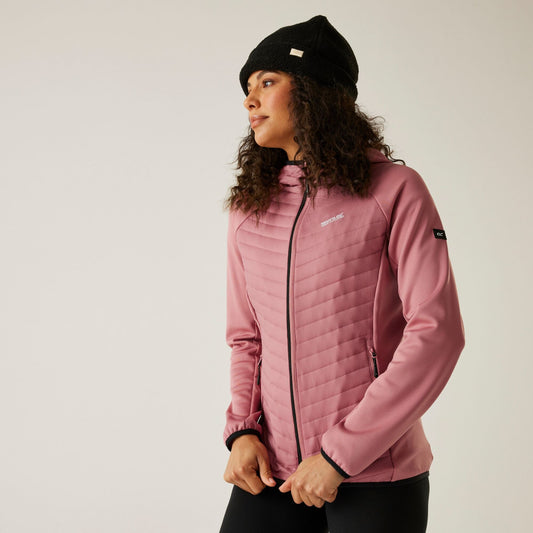 Person wearing a pink jacket and black beanie on a plain background