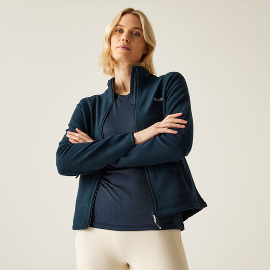 Woman wearing a dark blue jacket with a neutral background