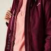 Close-up of a maroon jacket with a brand logo on a light background