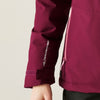 Close-up of a maroon jacket with a brand logo on a light background