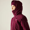 Person wearing a maroon hooded jacket with a visible brand logo on a plain background
