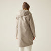 Person wearing a beige coat and brown beanie on a plain background