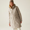 Woman wearing a beige parka and beanie on a plain background