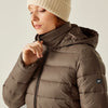 Person wearing a brown puffer jacket with a brand logo on a neutral background