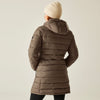 Person wearing a brown puffer coat and cream beanie on a beige background