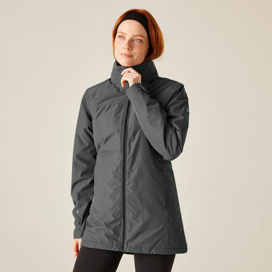 Woman wearing a gray jacket on a beige background