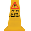 A yellow plastic warning cone sign with a red triangle and exclamation mark, and the text 'CAUTION SHEEP CROSSING' in black, isolated on a white background.