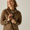 a woman wearing a cheetah print half zip fleece adjusting black zip